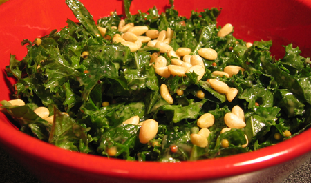 raw kale salad with toasted pine nuts